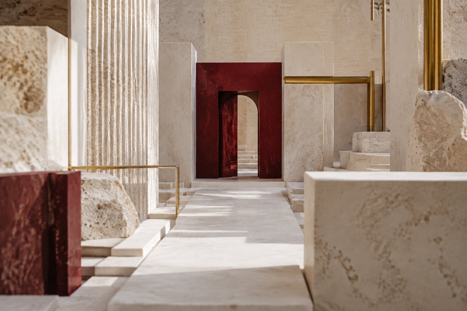 A burgundy doorway in a limestone architectural model, illustrating a redesigned web presence.