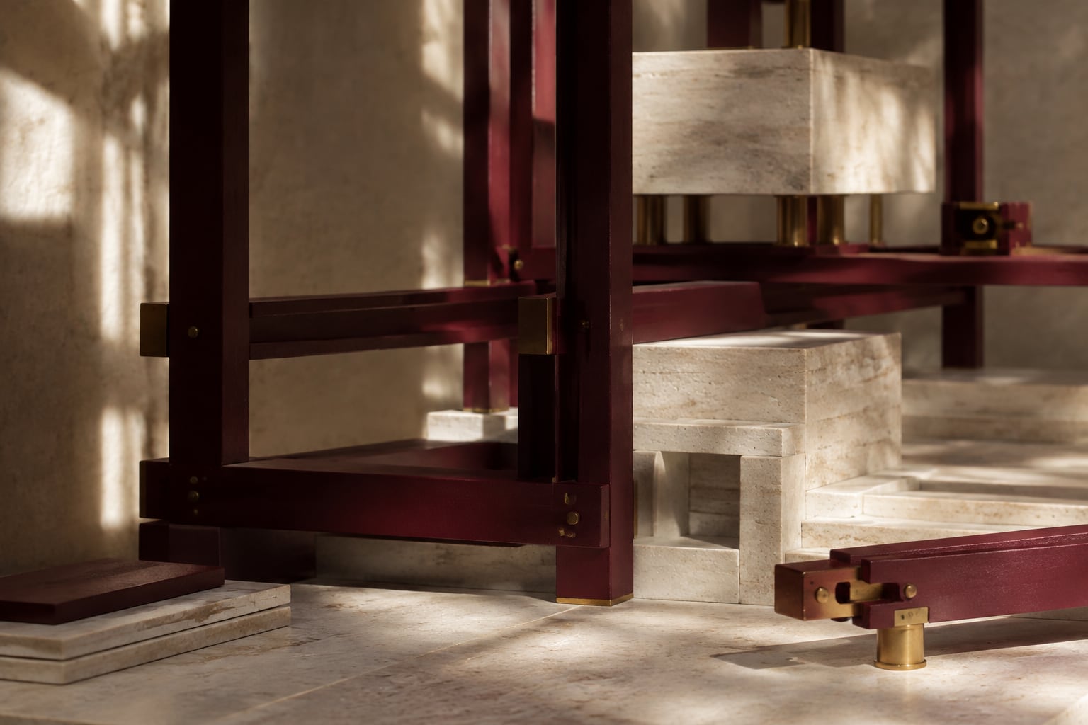 Precisely joined burgundy structural beams and limestone blocks in a physical model.